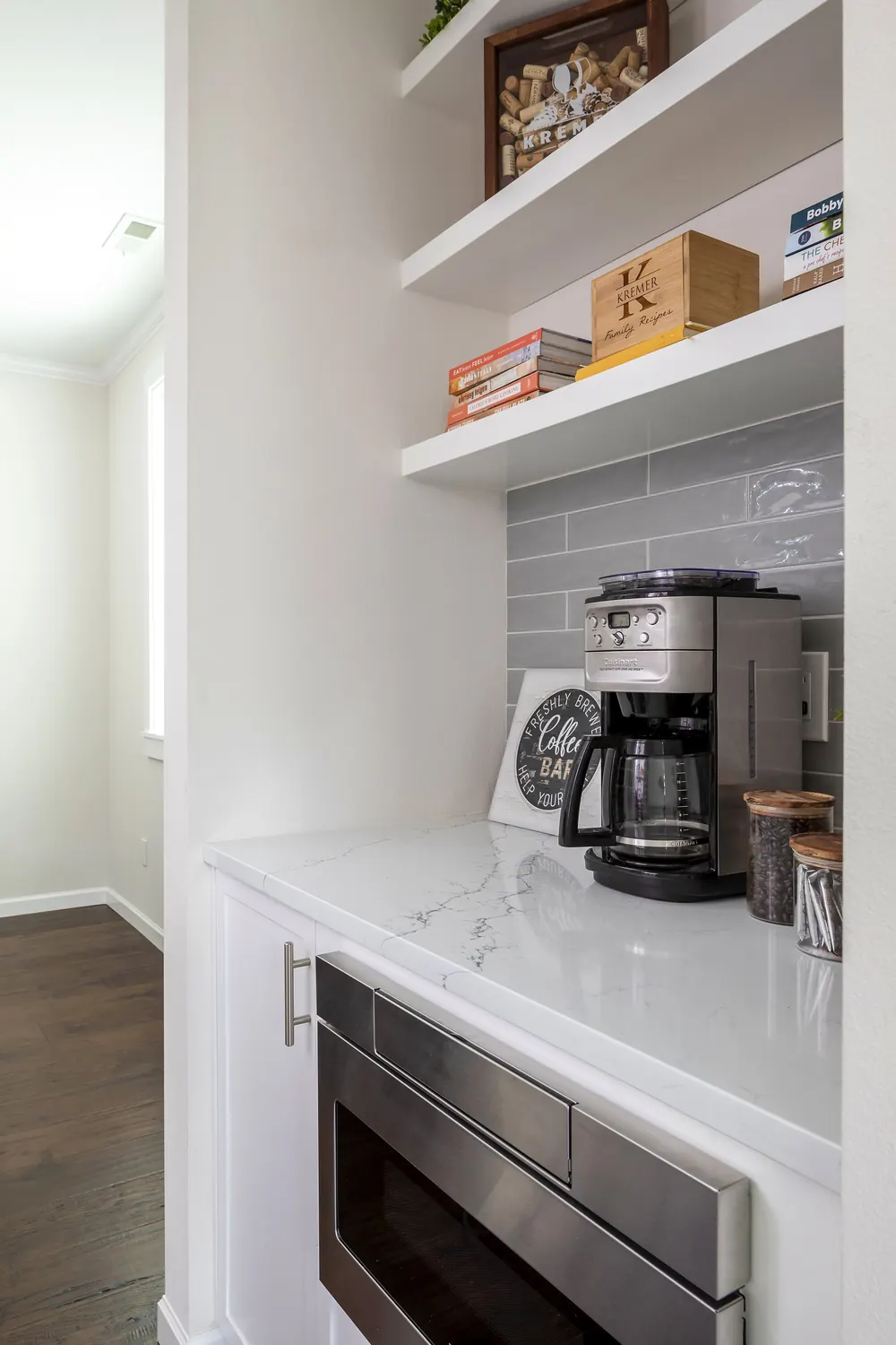 Coffee nook with open shelves above a built-in microwave
