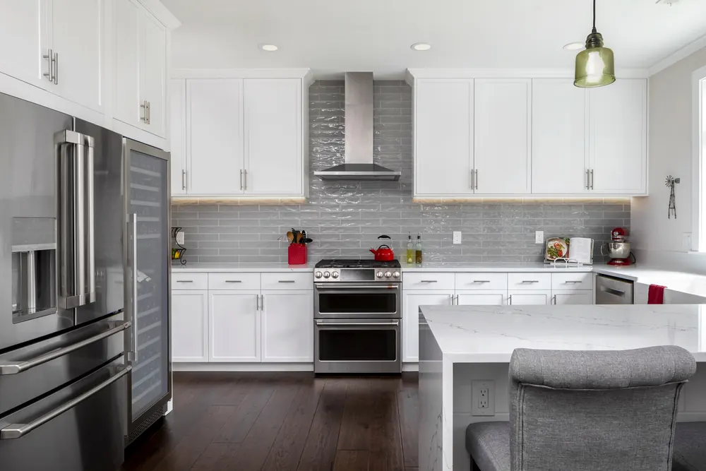 Kitchen with a French-door refrigerator and white cabinetry