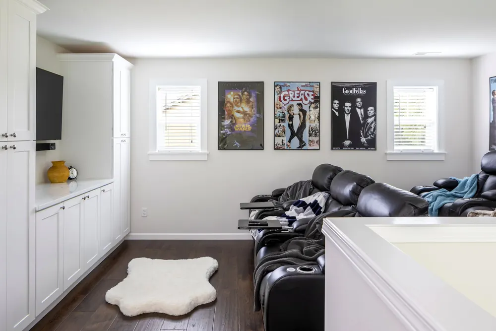 Family room with built-in cabinets and a TV wall