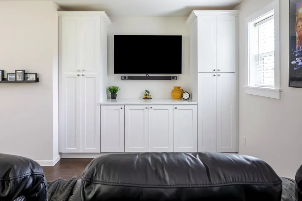 TV wall with built-in white cabinets