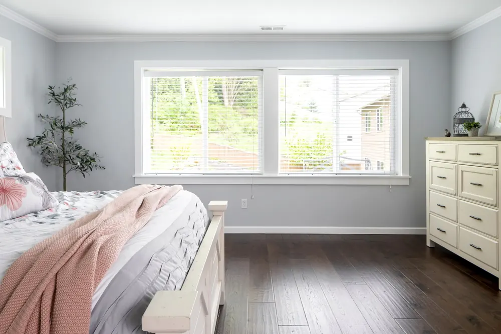 Bedroom with large windows and dark wood floors