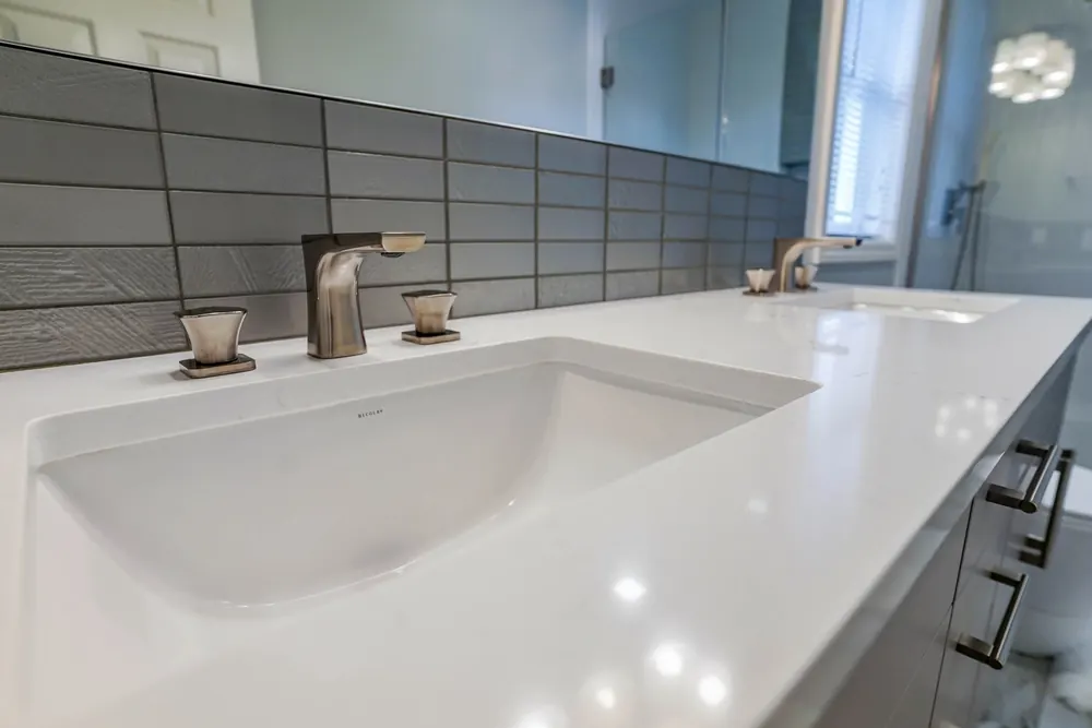 Undermount sink and faucet on a white vanity top