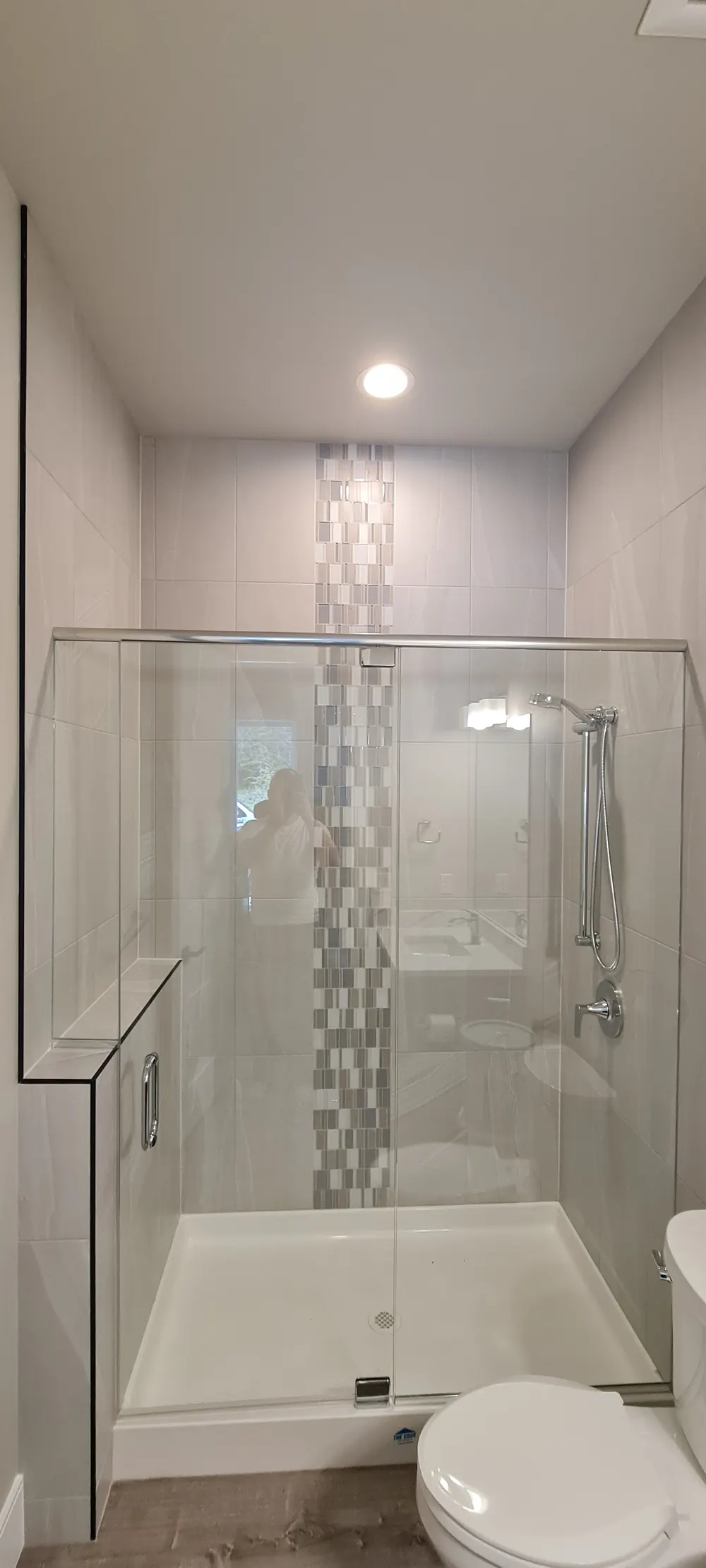 Glass shower with a mosaic accent stripe