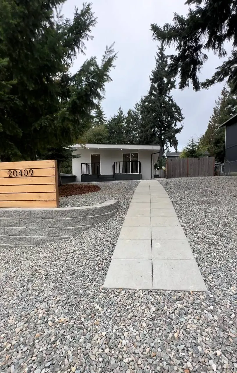 Gravel yard with a paver walkway to a single-story house