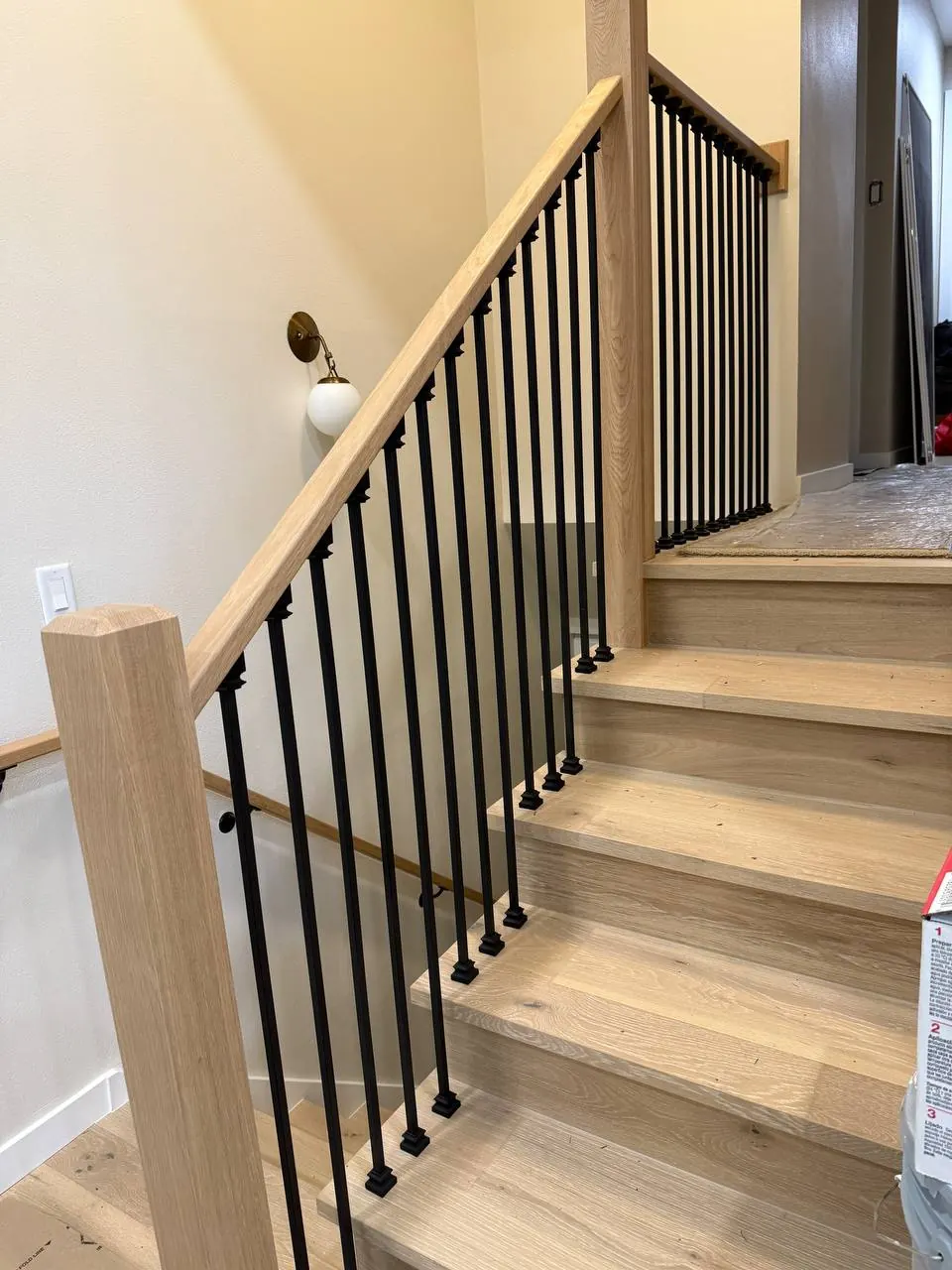 Staircase with wood treads and black metal balusters