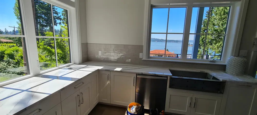 Kitchen corner with a farmhouse sink and large windows