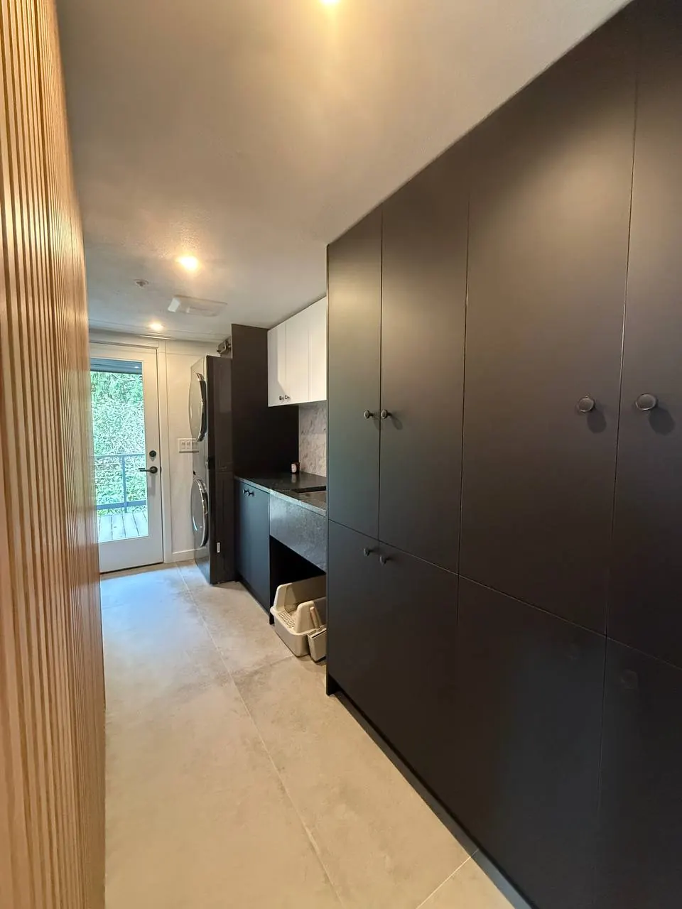 Tall black cabinet wall with a built-in desk nook