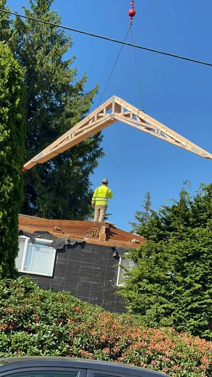 Roof truss being set from a crane