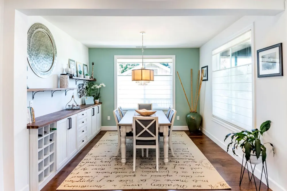 Dining area with a long wall shelf and cabinets