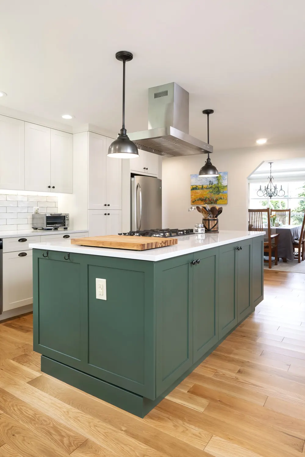 Green island and white cabinets seen from the dining side