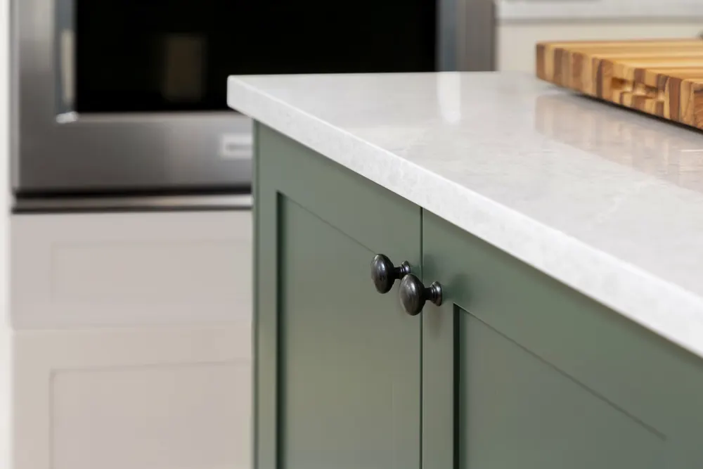Green cabinet base with a white counter edge