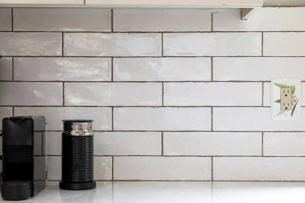 White subway tile backsplash with a coffee station