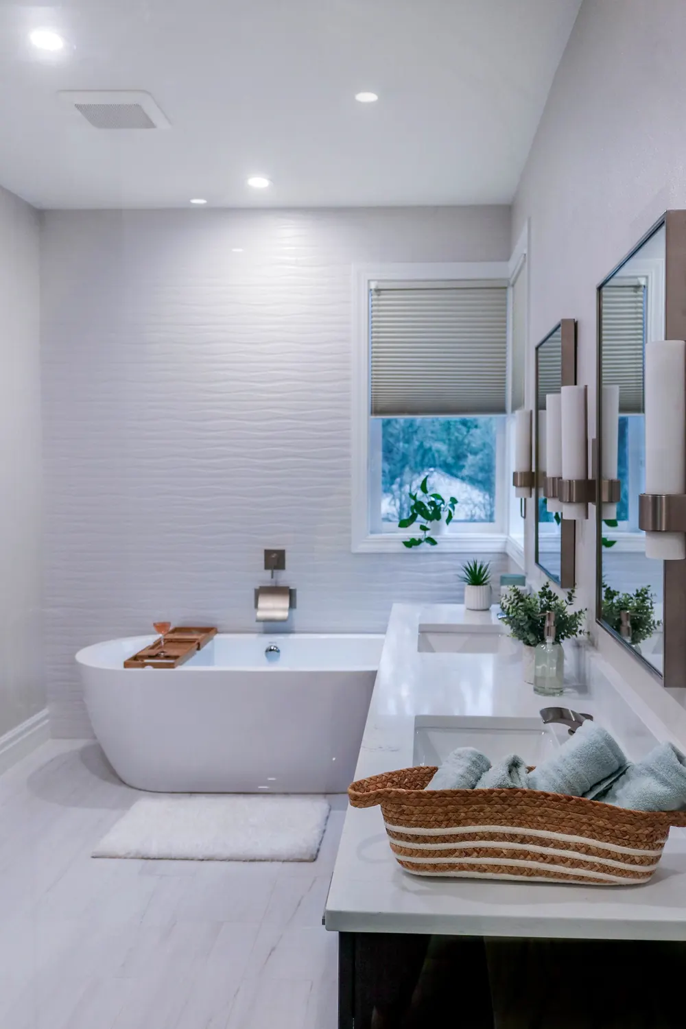 Freestanding tub under a window, with the vanity alongside