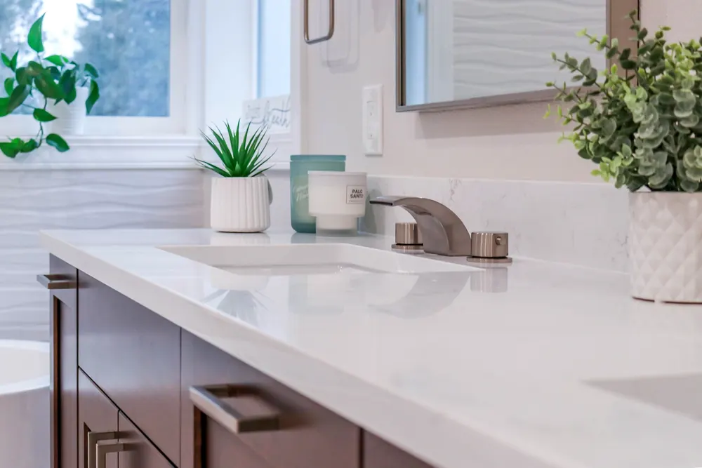 White vanity top with an undermount sink and bronze faucet