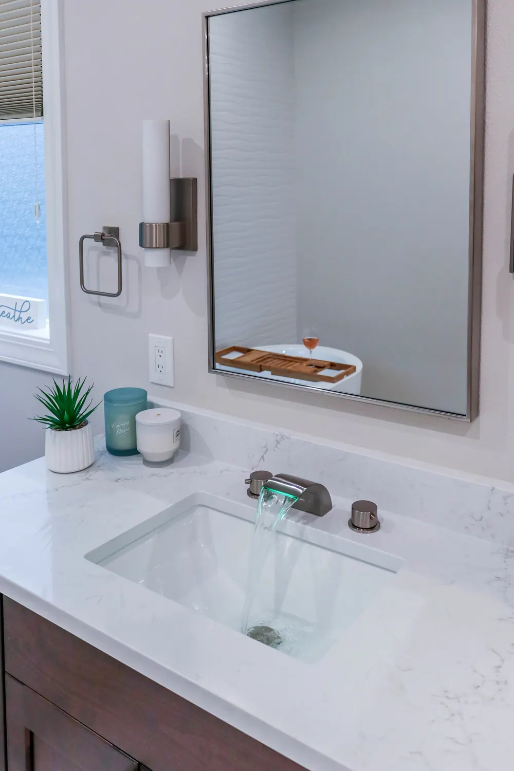 Vanity with a tall mirror and bronze sconces