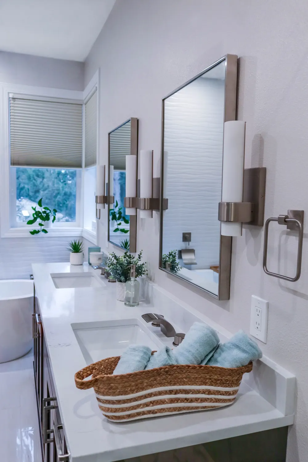 Double vanity with a basket and rolled towels