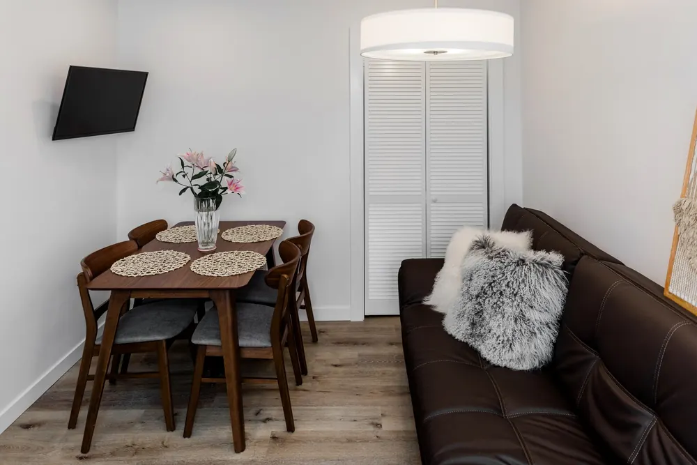 Dining area with a wood table next to the living room