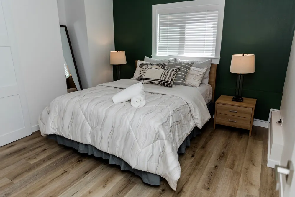 Bedroom with a dark green accent wall