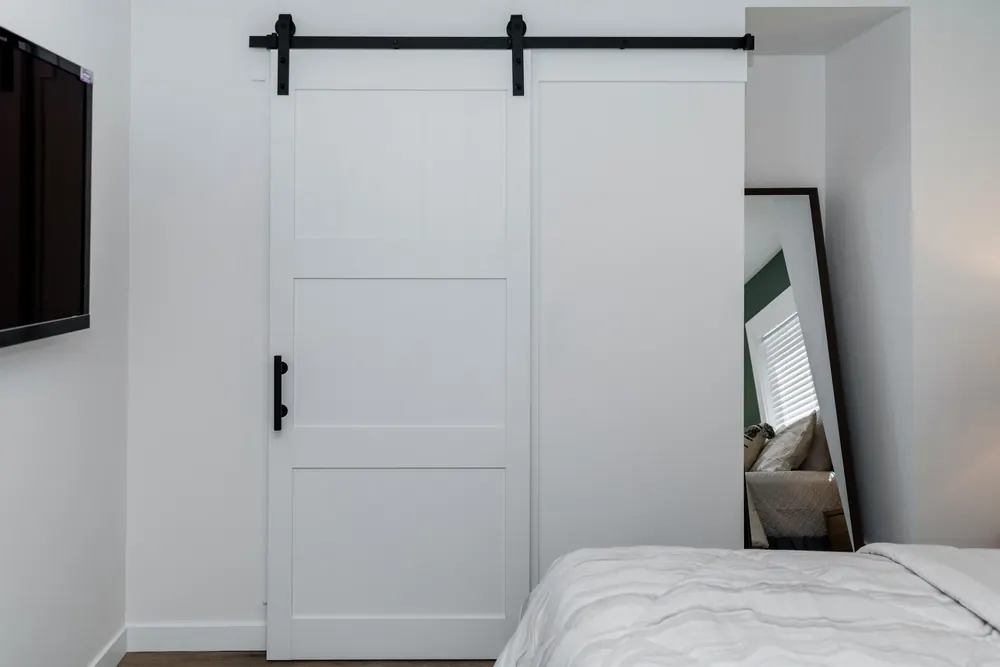White sliding barn door in a bedroom