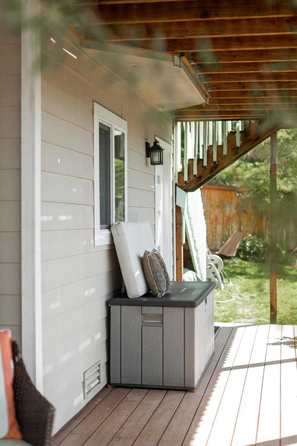Deck corner with a storage bench beside the house