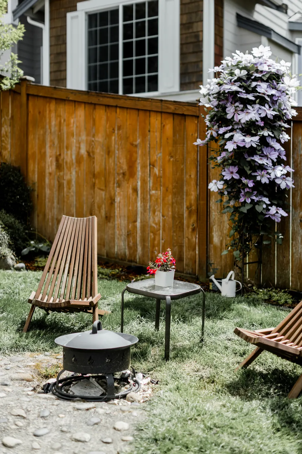Fenced backyard with seating and a fire pit