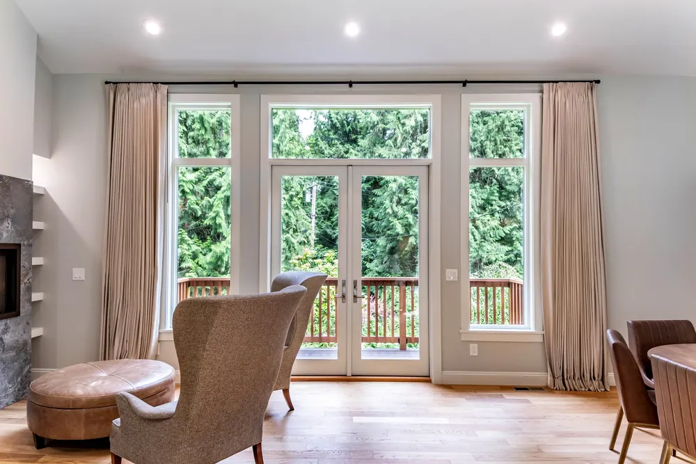 Living room with French doors, curtains and a fireplace