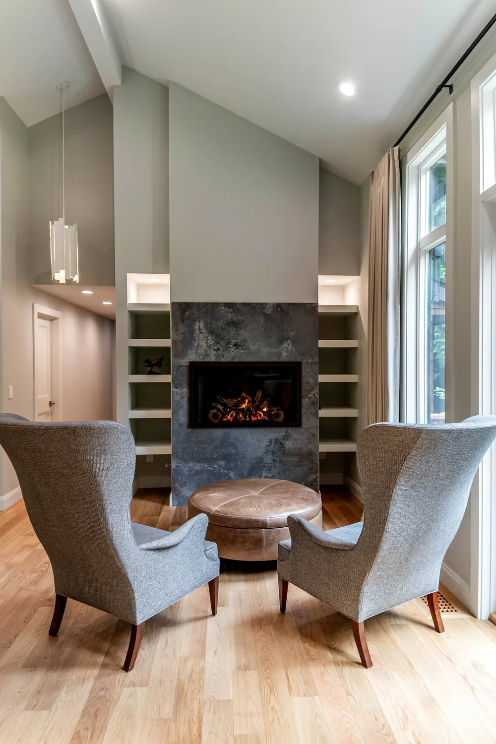 Fireplace with armchairs and built-in shelving