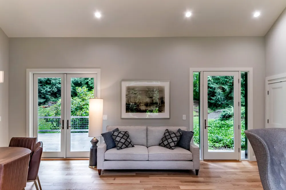 Living room with a sofa and French doors to the yard