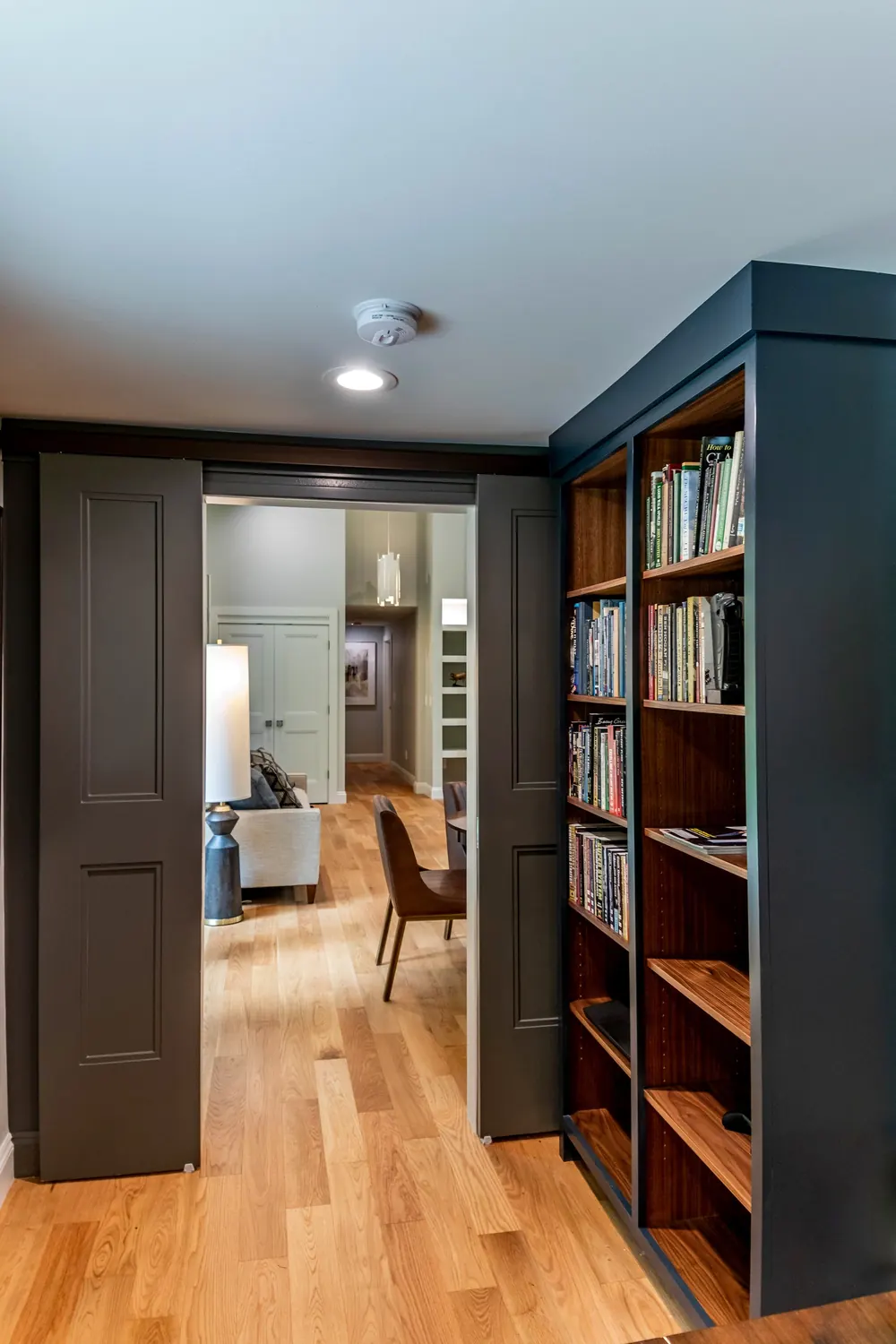 Dark bookcase with a view through the doorway
