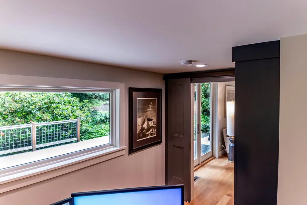 Wide window and dark built-in cabinet in the office