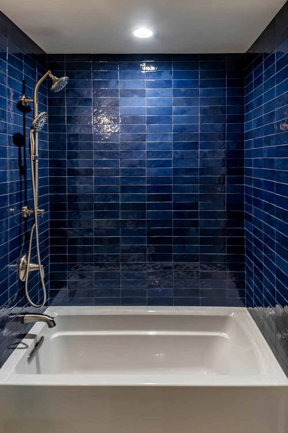 Tub-shower with deep blue glossy tile