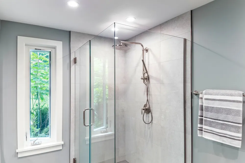 Glass shower with handheld and rain shower heads