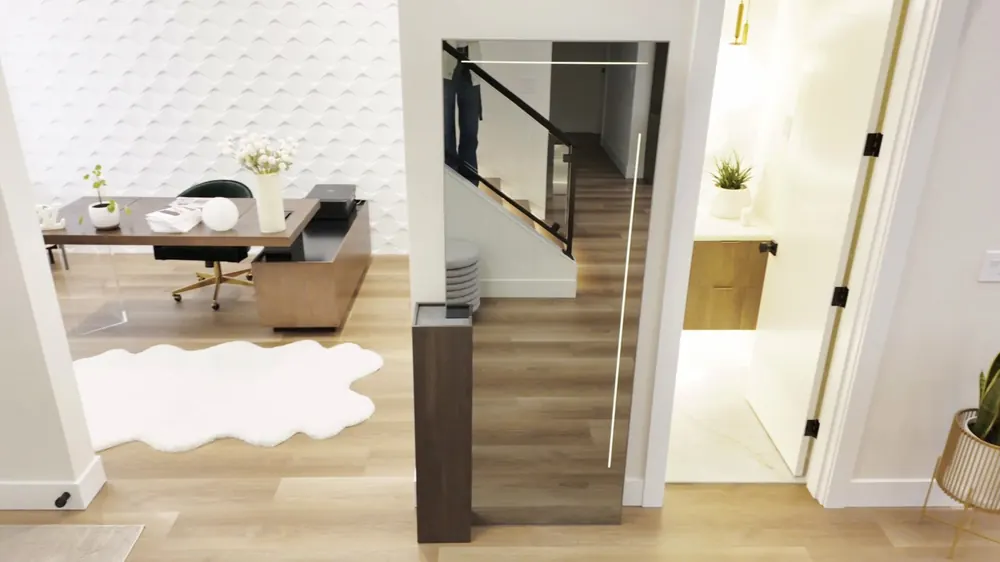 Living area with the staircase and a textured 3D wall