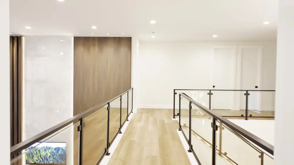 Upper hall with glass and metal railings