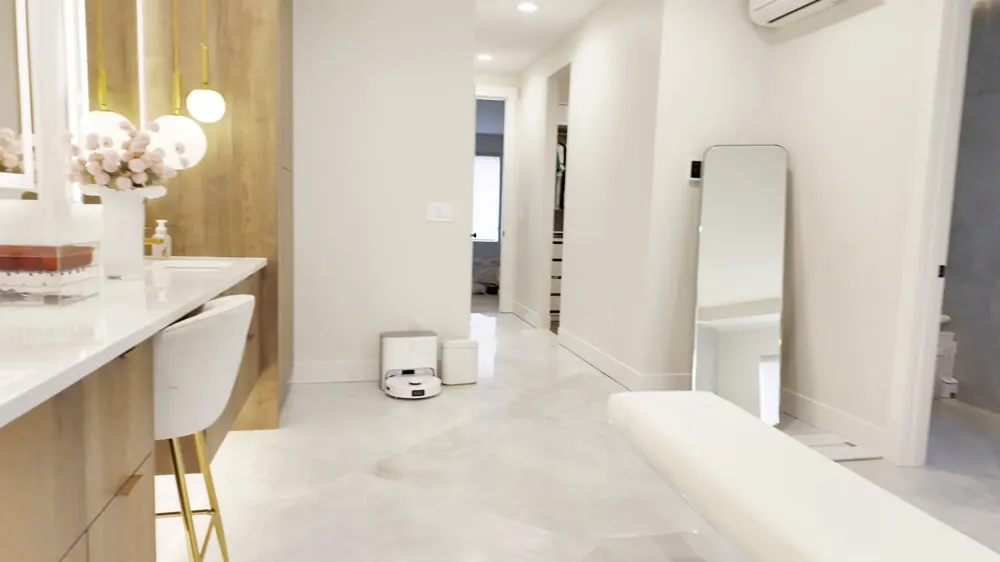 Primary bath with a freestanding tub and wood vanity