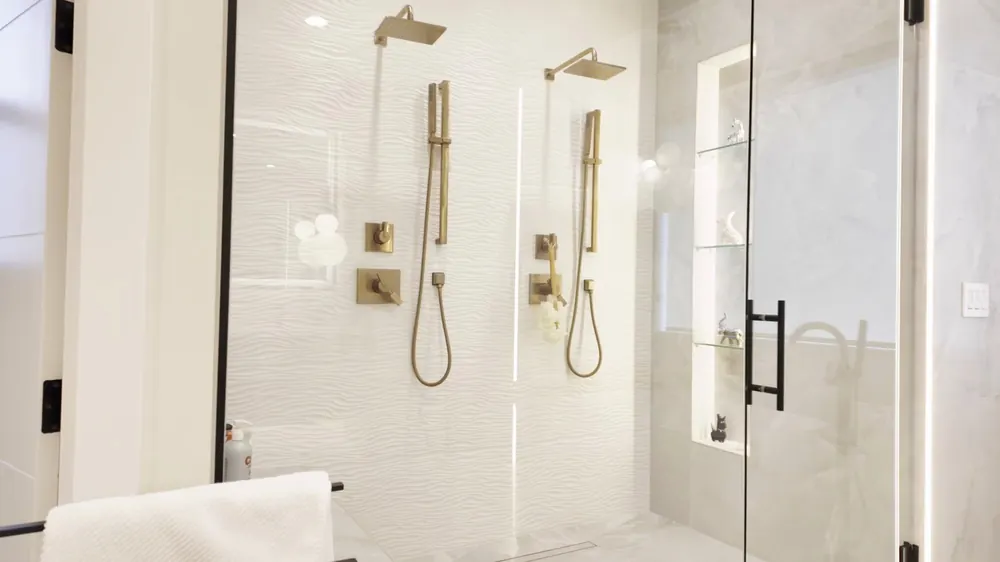 Glass shower and tub with gold fixtures